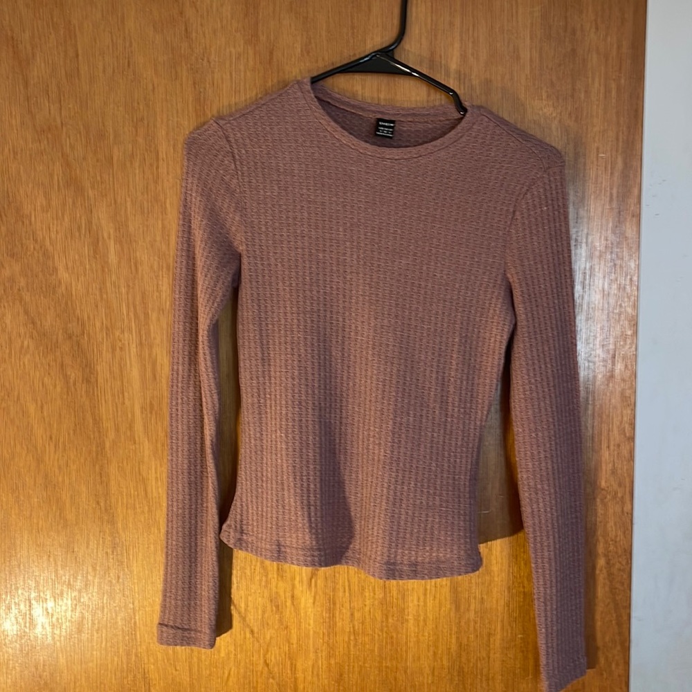 This is a light long sleeve shirt.Perfect for any wether. It has never been warn